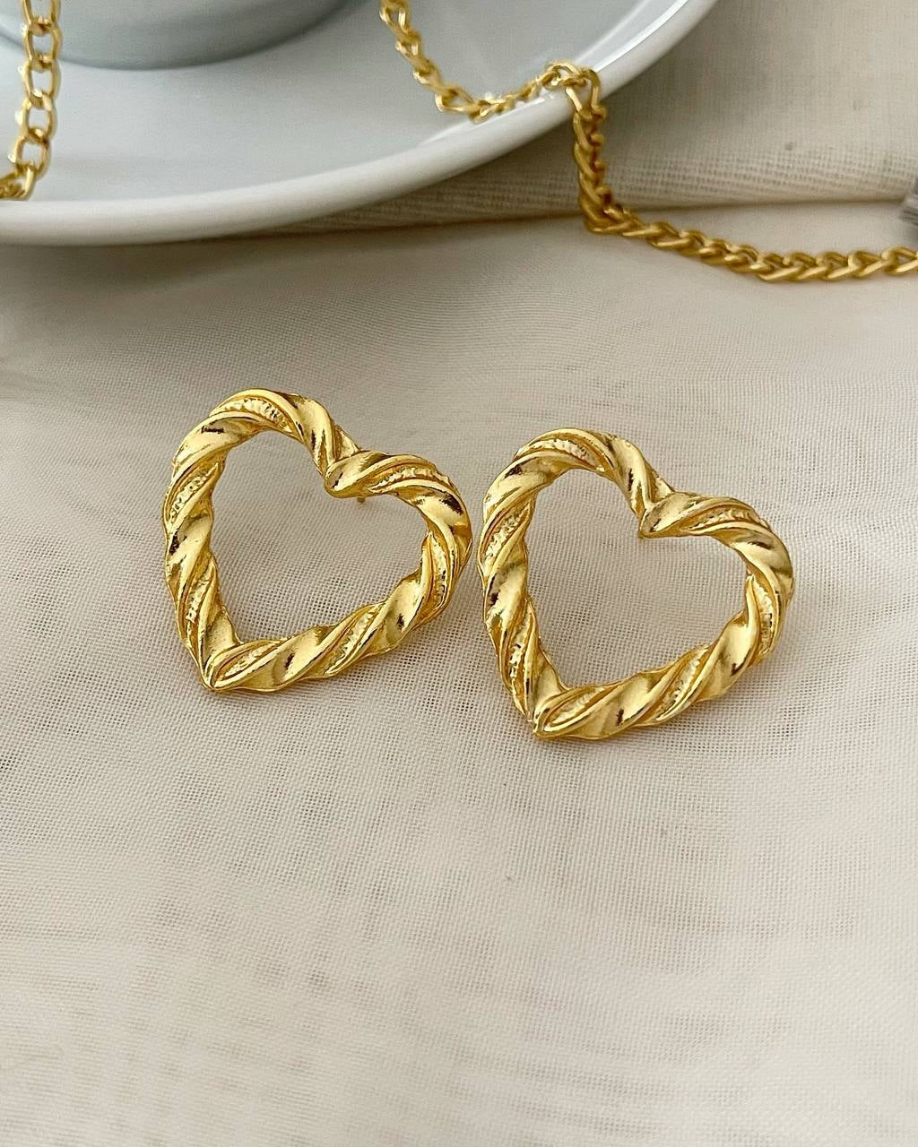 Brinco Folheado a ouro 18k coração torcido.