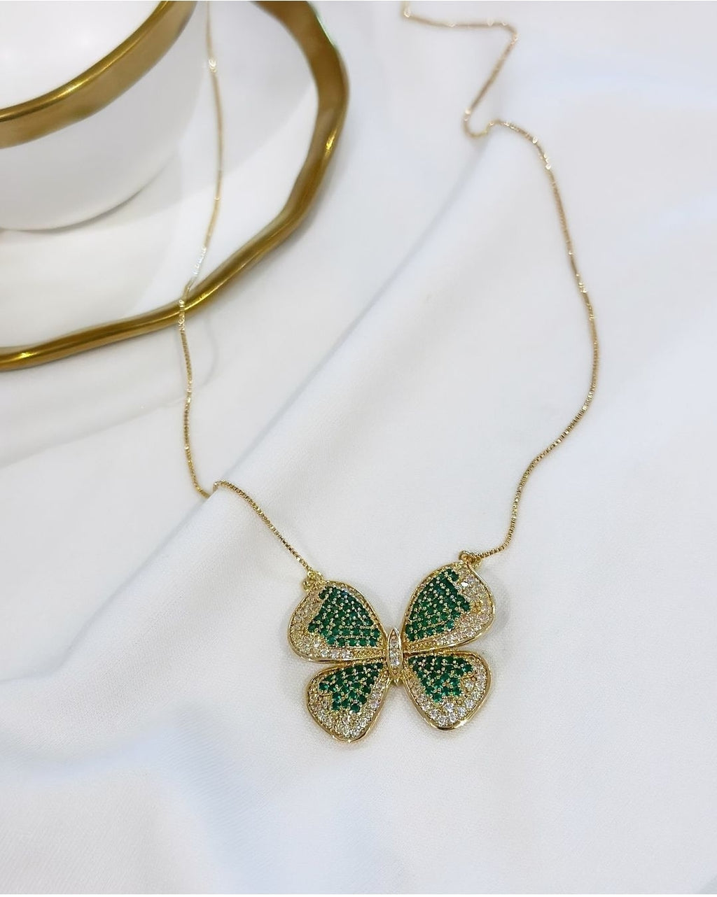 18k gold plated butterfly necklace studded with green zirconia.
