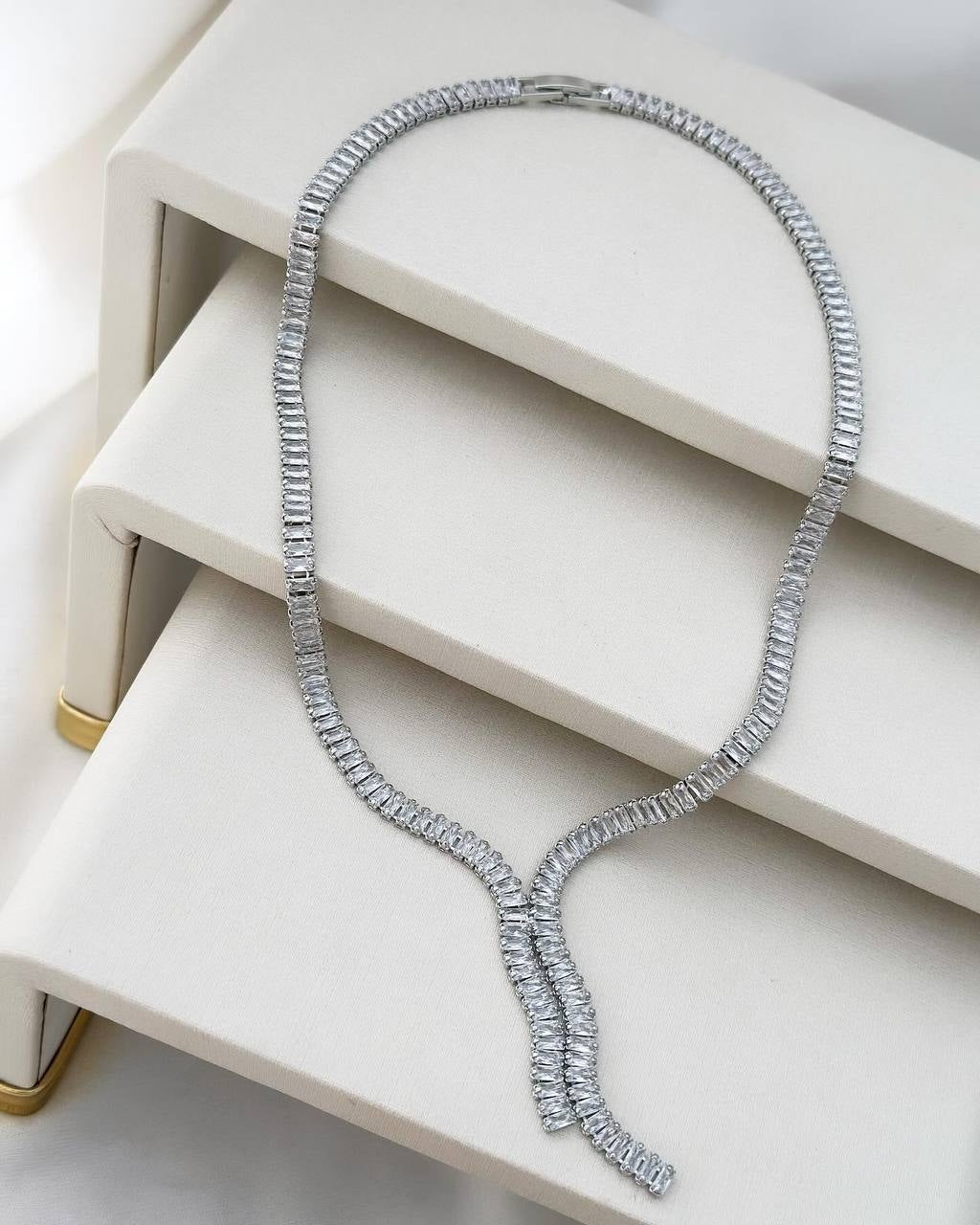 Silver plated necklace with chain and studded with a point of light.
